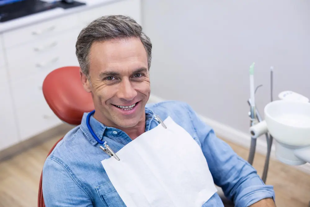 Middle-aged man getting teeth cleaned at the dentist